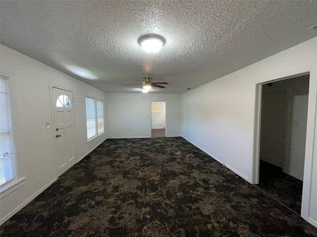 207 Bellview St, Sulphur Springs, TX 75482 - foyer entrance with a textured ceiling, ceiling fan, carpet, and baseboards
