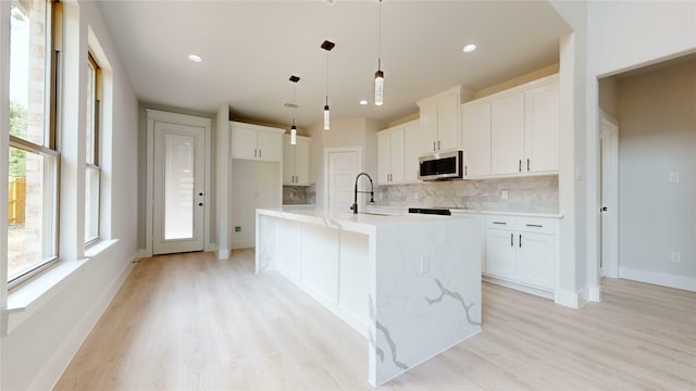 6860 Zuefeldt Dr, Arlington, TX 76002 - kitchen with stainless steel microwave, tasteful backsplash, light wood finished floors, white cabinets, and recessed lighting