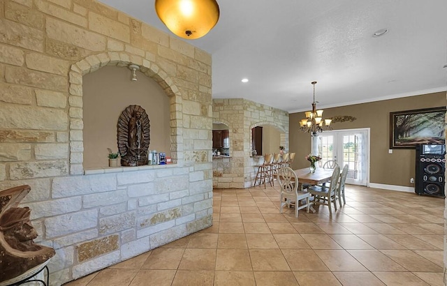 355 Texas 236 Hwy, Moody, TX 76557 - dining space featuring a chandelier, tile patterned floors, arched walkways, ornamental molding, and baseboards