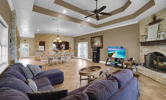 355 Texas 236 Hwy, Moody, TX 76557 - living area with light tile patterned floors, a chandelier, a ceiling fan, a fireplace, and a tray ceiling