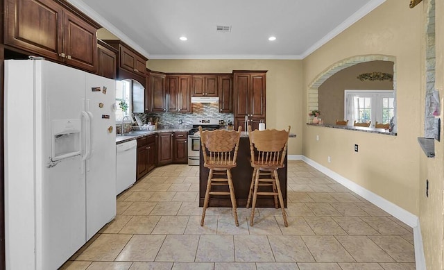 355 Texas 236 Hwy, Moody, TX 76557 - kitchen with white appliances, arched walkways, a sink, ornamental molding, and backsplash