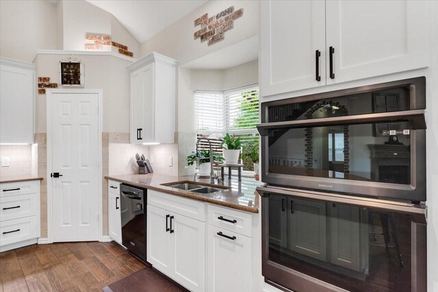 11538 Corsicana Dr, Frisco, TX 75035 - kitchen featuring black dishwasher, white cabinetry, dark wood-type flooring, a sink, and lofted ceiling