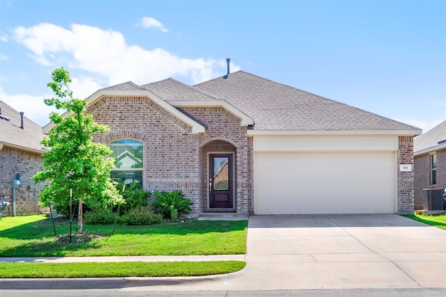 511 Poplar St, Princeton, TX 75407 - french country inspired facade featuring brick siding, driveway, an attached garage, a front yard, and cooling unit