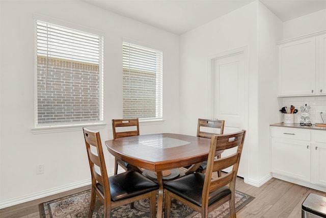 511 Poplar St, Princeton, TX 75407 - dining space with light wood finished floors, a bar, and baseboards