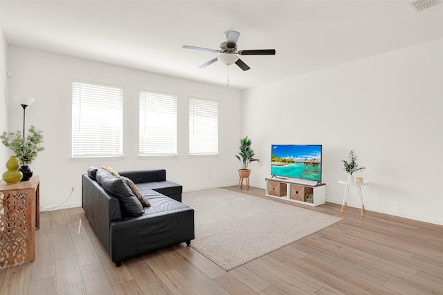 511 Poplar St, Princeton, TX 75407 - living area with light wood-style floors, a ceiling fan, and baseboards