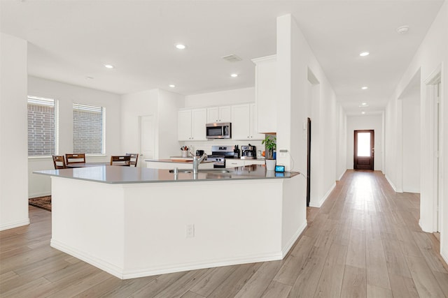511 Poplar St, Princeton, TX 75407 - kitchen with stainless steel appliances, a sink, white cabinets, light wood-style flooring, and recessed lighting