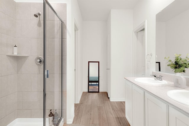 511 Poplar St, Princeton, TX 75407 - full bath with a stall shower, wood finished floors, double vanity, and baseboards
