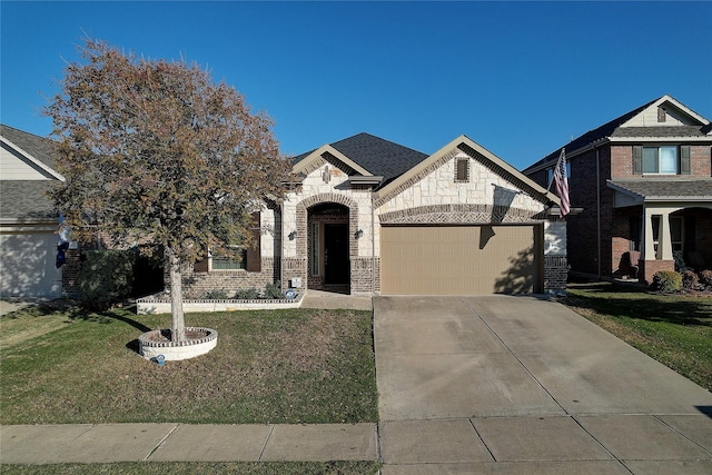 4921 Mcclellan Dr, Frisco, TX 75036 - view of front of house featuring a garage, a front yard, concrete driveway, stone siding, and brick siding