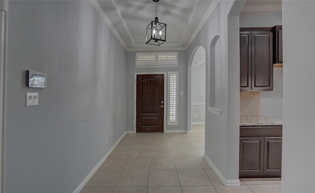 4921 Mcclellan Dr, Frisco, TX 75036 - entryway featuring arched walkways, ornamental molding, light tile patterned floors, baseboards, and a chandelier