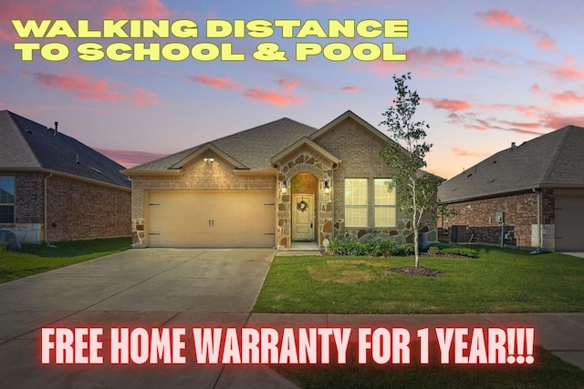 10425 Ponderosa Trl, Aubrey, TX 76227 - view of front of home featuring an attached garage, a lawn, concrete driveway, brick siding, and stone siding