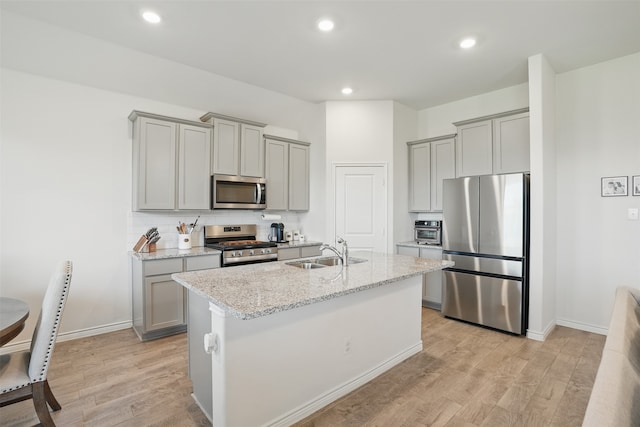 10425 Ponderosa Trl, Aubrey, TX 76227 - kitchen featuring appliances with stainless steel finishes, gray cabinets, light wood-style flooring, and recessed lighting
