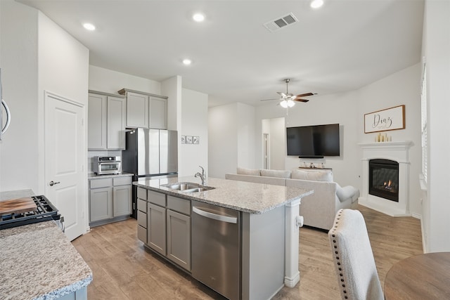10425 Ponderosa Trl, Aubrey, TX 76227 - kitchen with stainless steel appliances, gray cabinetry, light wood-type flooring, a ceiling fan, and recessed lighting