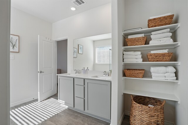 10425 Ponderosa Trl, Aubrey, TX 76227 - full bathroom featuring double vanity, wood finished floors, and recessed lighting