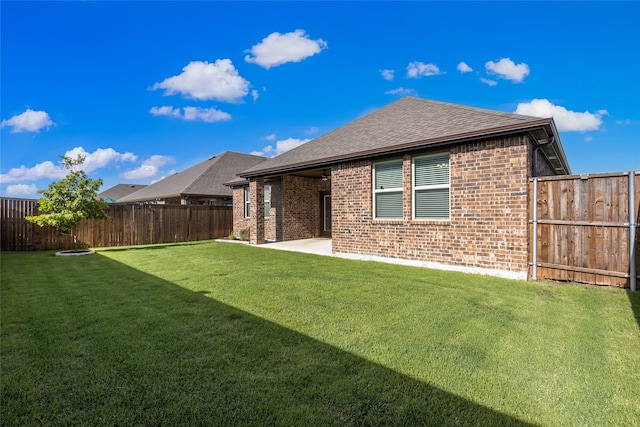855 Revere Ct, Fate, TX 75189 - back of property featuring brick siding, a shingled roof, and a patio area