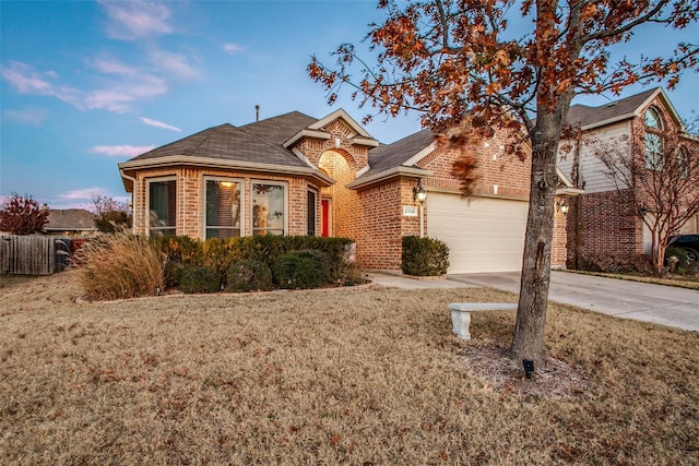 2318 Sparrow Dr, Forney, TX 75126 - view of front of home with brick siding, an attached garage, concrete driveway, and roof with shingles
