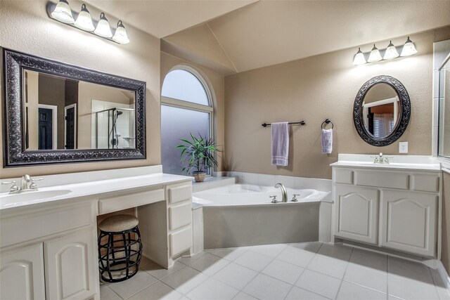 2318 Sparrow Dr, Forney, TX 75126 - full bathroom featuring tile patterned floors, a bath, two vanities, a shower stall, and vaulted ceiling