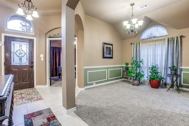 2318 Sparrow Dr, Forney, TX 75126 - foyer entrance with a chandelier, arched walkways, lofted ceiling, light tile patterned floors, and light carpet