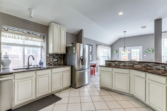 3832 Creekside Ln, Carrollton, TX 75010 - kitchen featuring a sink, stainless steel appliances, tasteful backsplash, lofted ceiling, and a chandelier