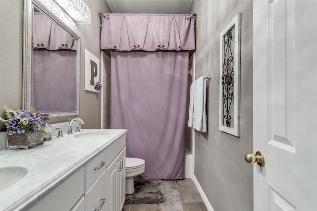 3832 Creekside Ln, Carrollton, TX 75010 - bathroom featuring double vanity, toilet, tile patterned floors, shower / tub combo, and baseboards