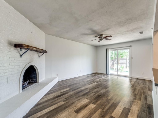 4857 Fallon Pl, Dallas, TX 75227 - unfurnished living room with ceiling fan, dark wood finished floors, a brick fireplace, and baseboards