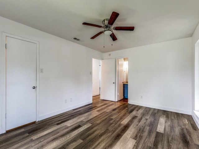 4857 Fallon Pl, Dallas, TX 75227 - unfurnished bedroom featuring wood finished floors, baseboards, and ensuite bathroom