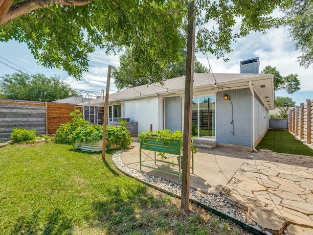 4857 Fallon Pl, Dallas, TX 75227 - back of house with a patio area, a chimney, and brick siding