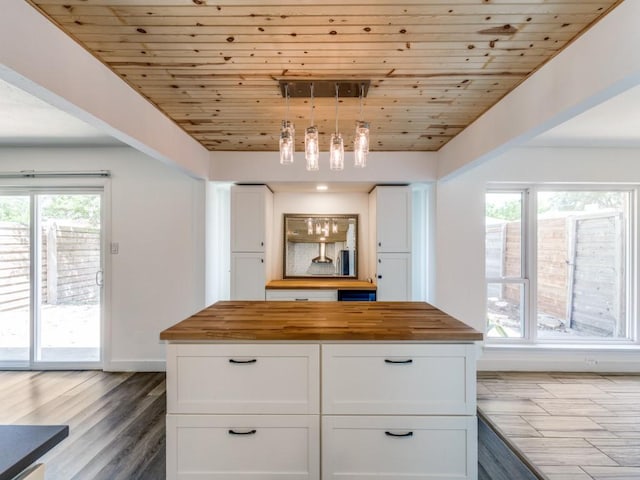 4857 Fallon Pl, Dallas, TX 75227 - kitchen with wood counters, white cabinetry, wood ceiling, wood finished floors, and hanging light fixtures