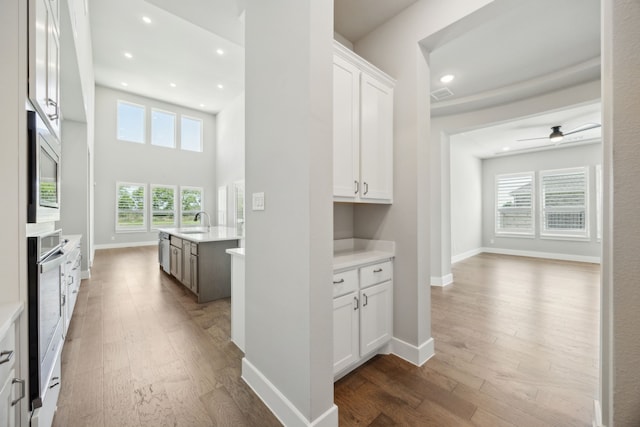 4106 Tamarack Ln, Royse City, TX 75189 - hallway with a sink, dark wood-style flooring, baseboards, and recessed lighting