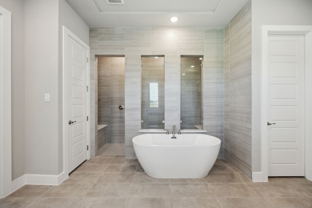 4106 Tamarack Ln, Royse City, TX 75189 - full bath with tile patterned flooring, a freestanding bath, baseboards, and tile walls