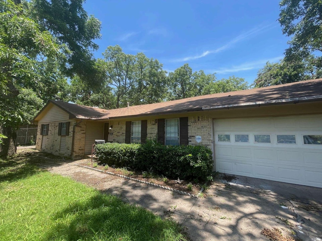 802 Pecan St, Bonham, TX 75418 - ranch-style home with an attached garage, brick siding, and driveway