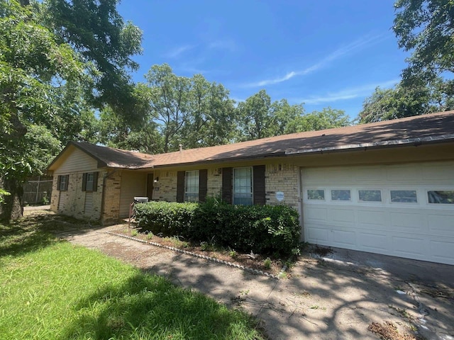 802 Pecan St, Bonham, TX 75418 - ranch-style home with an attached garage, brick siding, and driveway