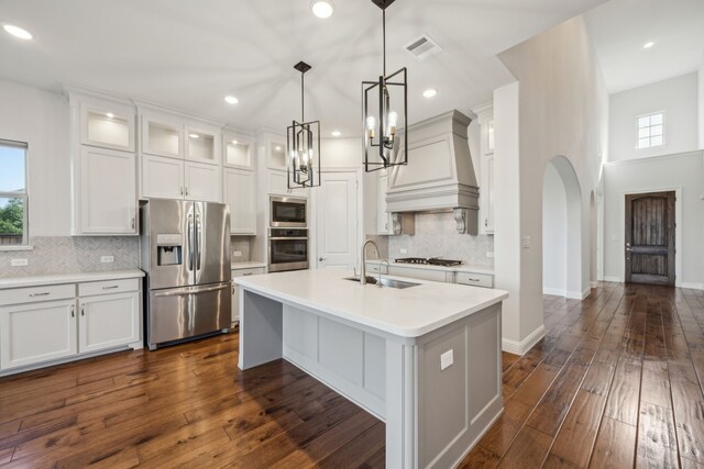 5901 Kildare Ct, Mckinney, TX 75071 - kitchen with appliances with stainless steel finishes, a sink, arched walkways, backsplash, and light countertops