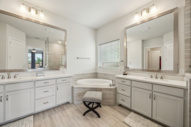 5901 Kildare Ct, Mckinney, TX 75071 - full bathroom with healthy amount of natural light, two vanities, and a bath
