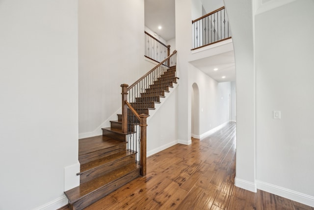 5901 Kildare Ct, Mckinney, TX 75071 - stairway with arched walkways, wood-type flooring, baseboards, a towering ceiling, and recessed lighting