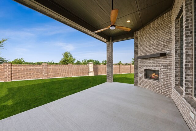 5901 Kildare Ct, Mckinney, TX 75071 - view of patio / terrace with an outdoor brick fireplace and a ceiling fan