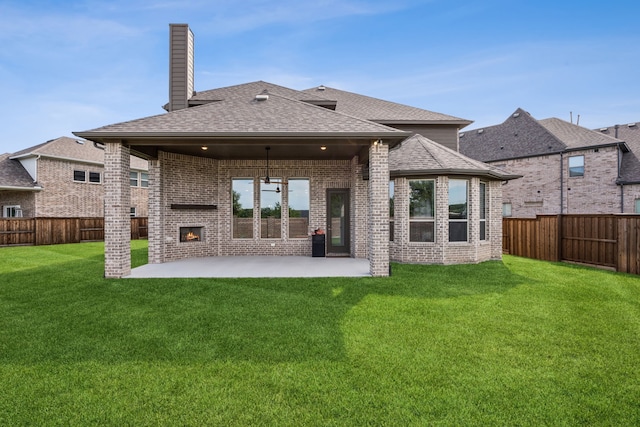 5901 Kildare Ct, Mckinney, TX 75071 - rear view of property featuring a fireplace, brick siding, a patio area, a shingled roof, and a chimney