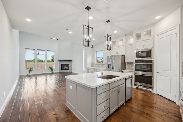 5901 Kildare Ct, Mckinney, TX 75071 - kitchen featuring a sink, appliances with stainless steel finishes, dark wood-style flooring, light countertops, and recessed lighting