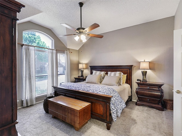 6023 Vista Ln, Sachse, TX 75048 - bedroom featuring lofted ceiling, light carpet, multiple windows, a textured ceiling, and a ceiling fan