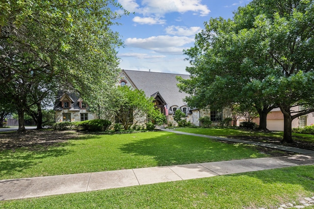 6707 Meadow Rd, Dallas, TX 75230 - view of front facade with stone siding and a front lawn