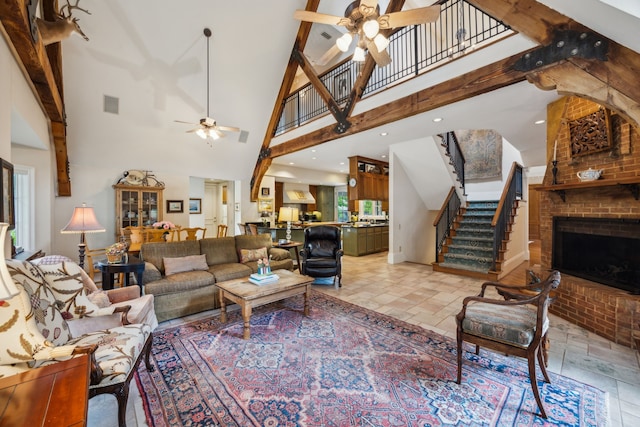 6707 Meadow Rd, Dallas, TX 75230 - living area with ceiling fan, stairs, a brick fireplace, stone tile floors, and a towering ceiling