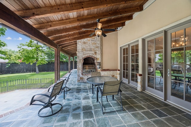 6707 Meadow Rd, Dallas, TX 75230 - view of patio / terrace with an outdoor stone fireplace, outdoor dining space, and a ceiling fan