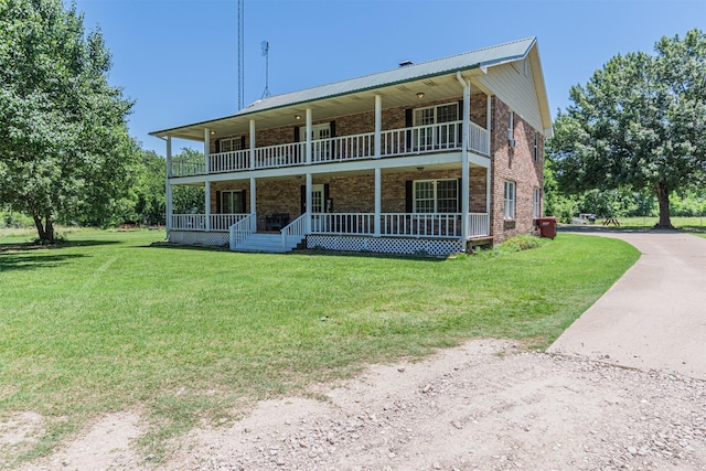 1147 Vz County Road 3417, Wills Point, TX 75169 - view of front of home featuring a porch, brick siding, a front lawn, and a balcony