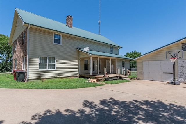 1147 Vz County Road 3417, Wills Point, TX 75169 - back of house with covered porch, a chimney, and a metal roof
