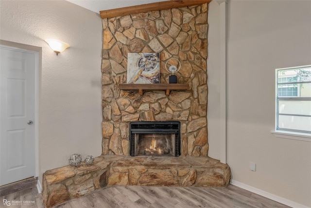 4102 Glen St, Bossier City, LA 71112 - unfurnished living room with wood finished floors, a fireplace, and baseboards