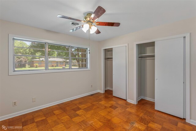 4102 Glen St, Bossier City, LA 71112 - unfurnished bedroom featuring two closets, multiple windows, and baseboards