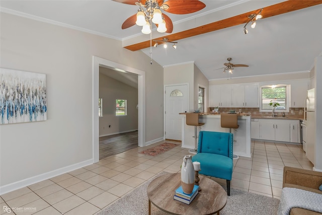 4102 Glen St, Bossier City, LA 71112 - living room featuring a ceiling fan, light tile patterned flooring, crown molding, and baseboards