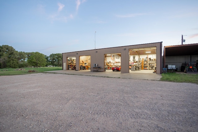 1343 Buster Chatham Rd, Waco, TX 76705 - view of building exterior featuring driveway, a garage, and an outbuilding