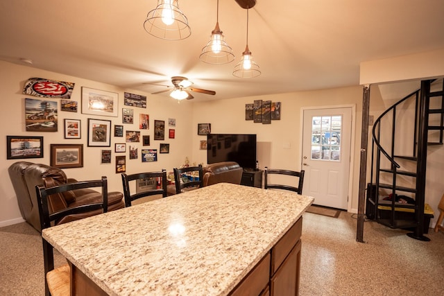 1343 Buster Chatham Rd, Waco, TX 76705 - kitchen featuring open floor plan, a ceiling fan, light stone counters, and hanging light fixtures
