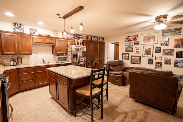 1343 Buster Chatham Rd, Waco, TX 76705 - kitchen featuring appliances with stainless steel finishes, a kitchen breakfast bar, ceiling fan, light colored carpet, and recessed lighting