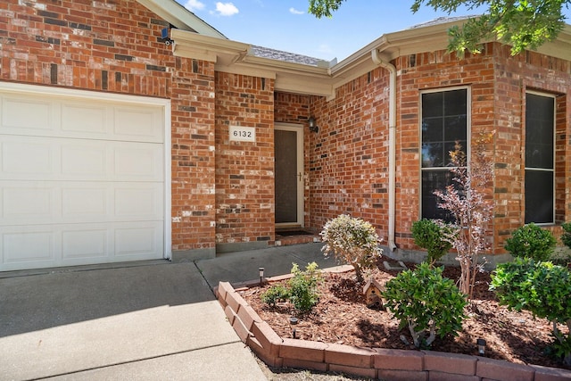 6132 Farrah Dr, Fort Worth, TX 76131 - view of exterior entry with an attached garage and brick siding